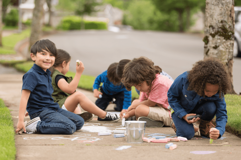 kids playing with chalk outside 