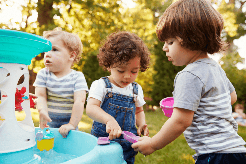 kids playing in a water table outside 